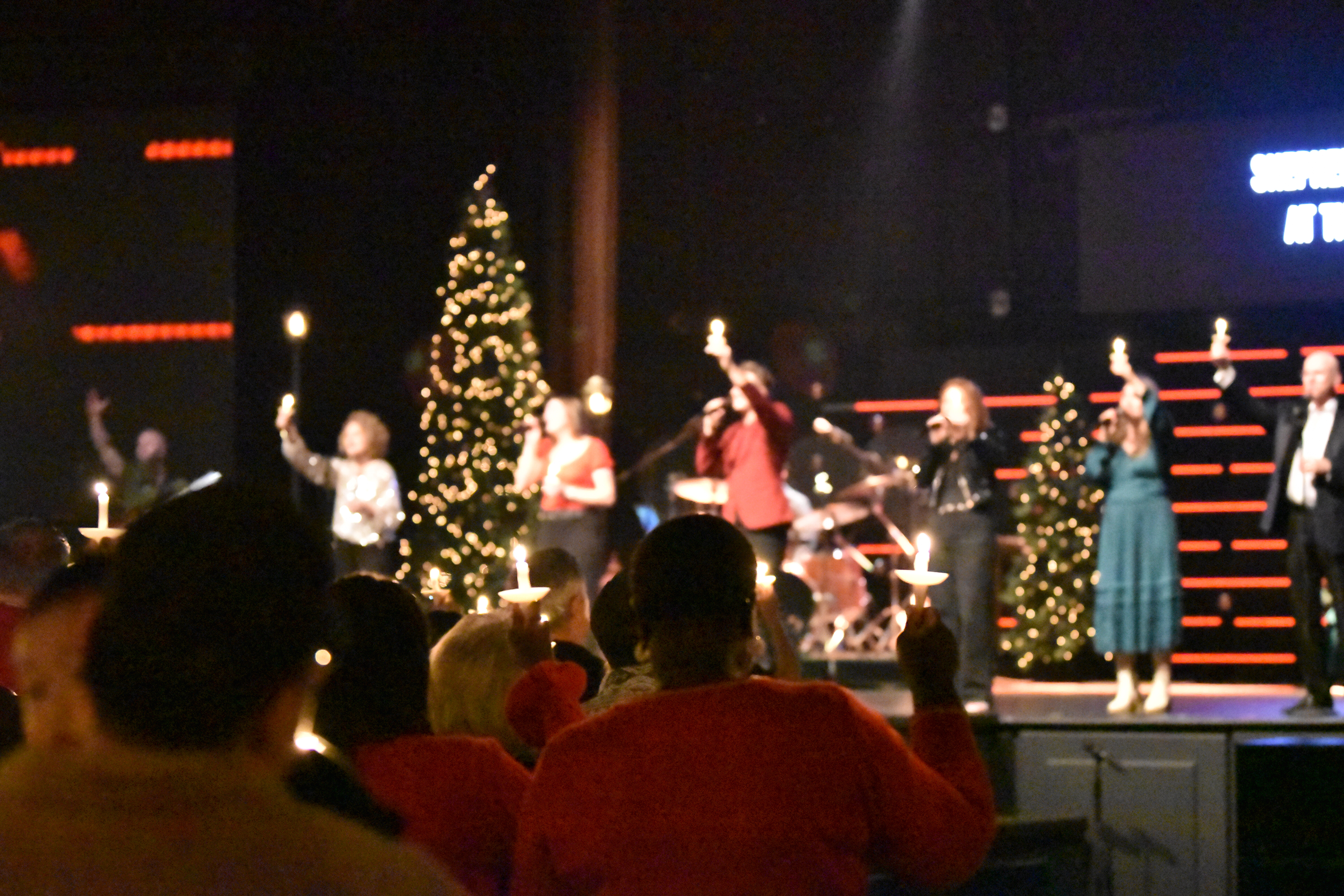 Worship band holding candles at Cross Pointe Christmas service