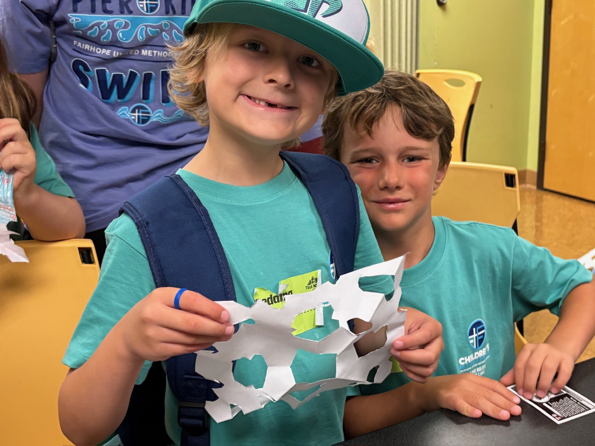 PIER KIDS boys holding paper snowflake craft