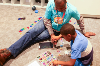 Volunteers sitting with kids