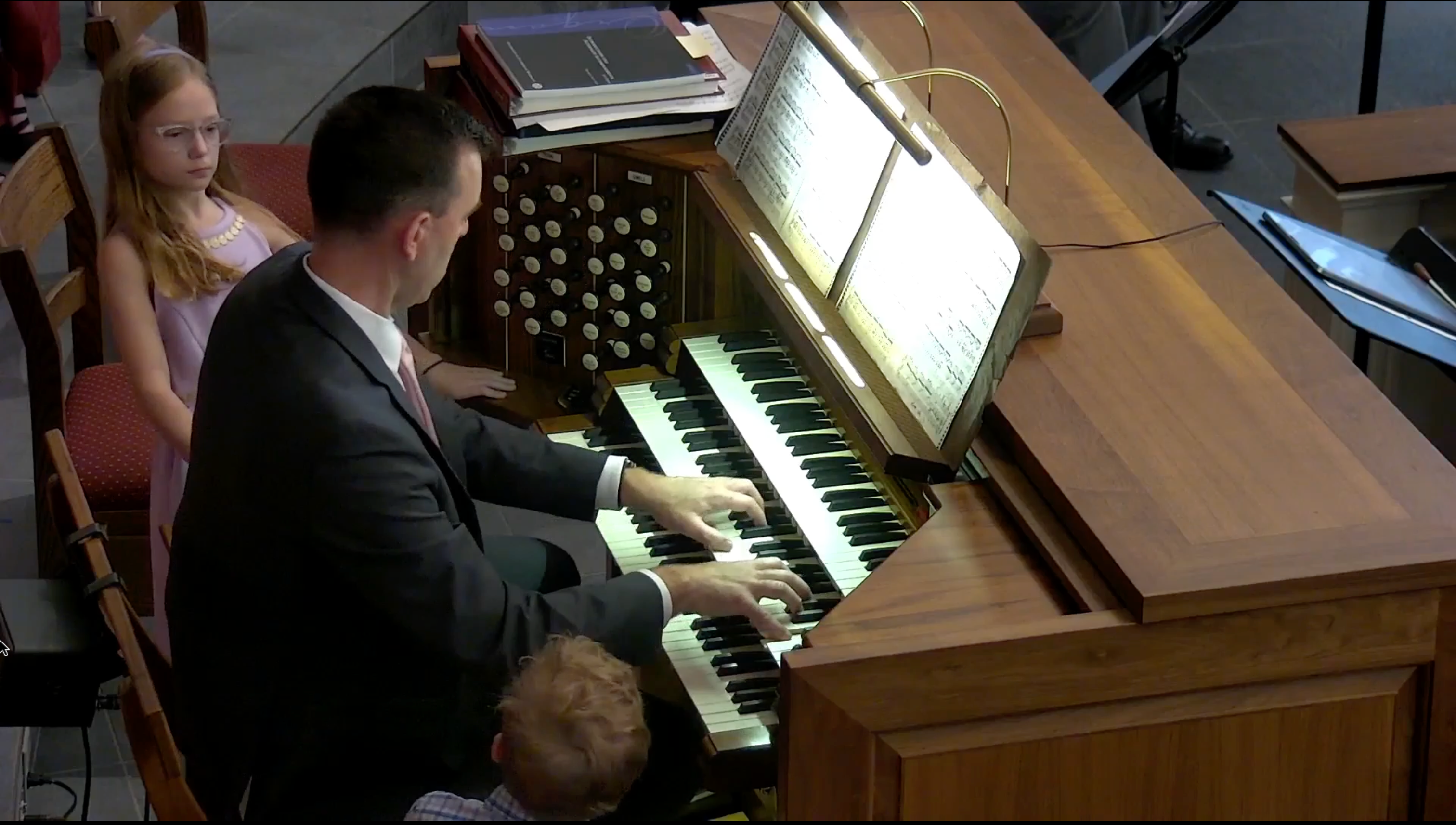 Children watching an organist play in church