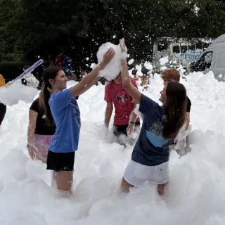 Youth playing outside in bubbles