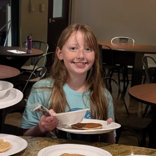 Youth holding a plate of food