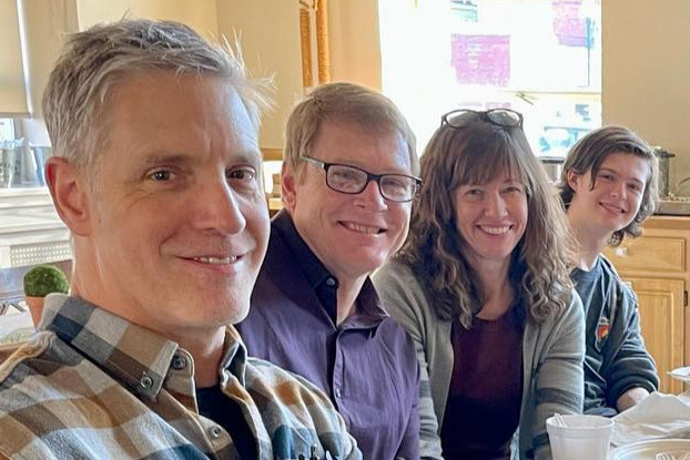 Group smiling at potluck