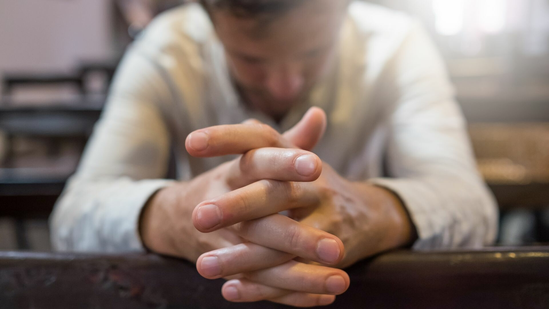 close-up-of-mans-praying-hands