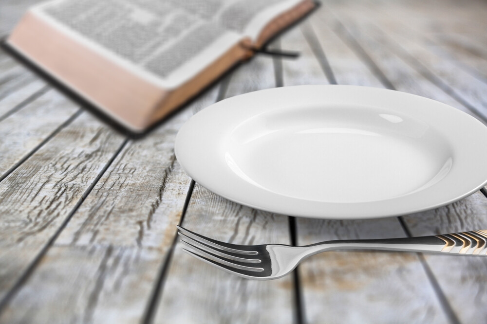 open-Bible-next-to-empty-plate