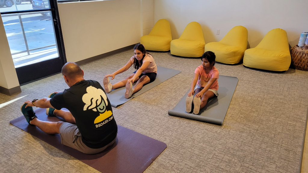 Students stretching on yoga mats in the fitness corner at Dream School of the Arts San Diego