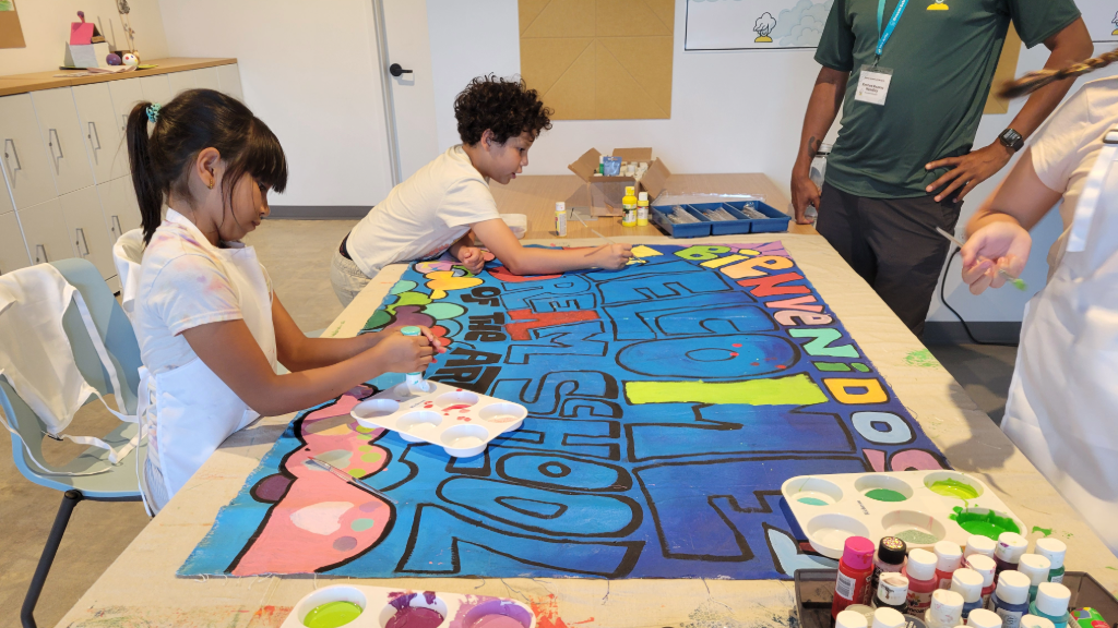 students painting welcome mural for Dream School of the Arts San Diego