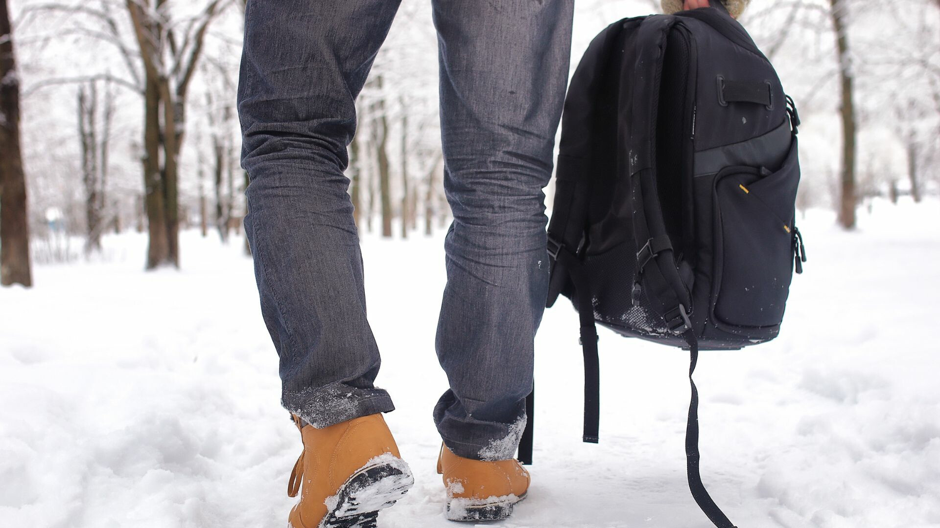 close-up-of-mans-feet-on-winter-walk