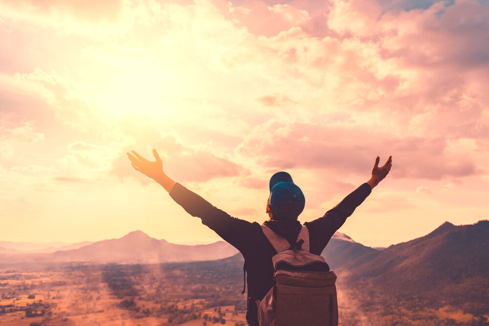 backpacker-man-hands-raised-to-heaven