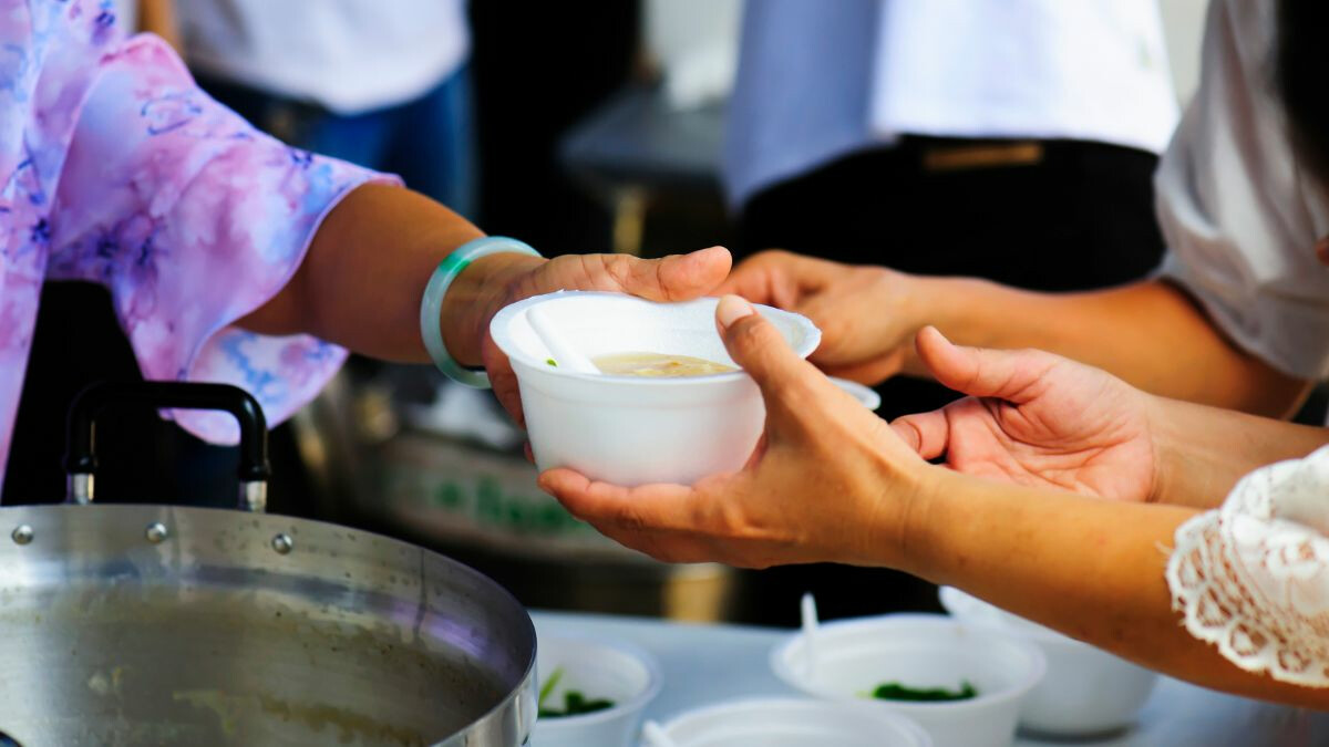 close-up-serving-others-a-bowl-of-soup