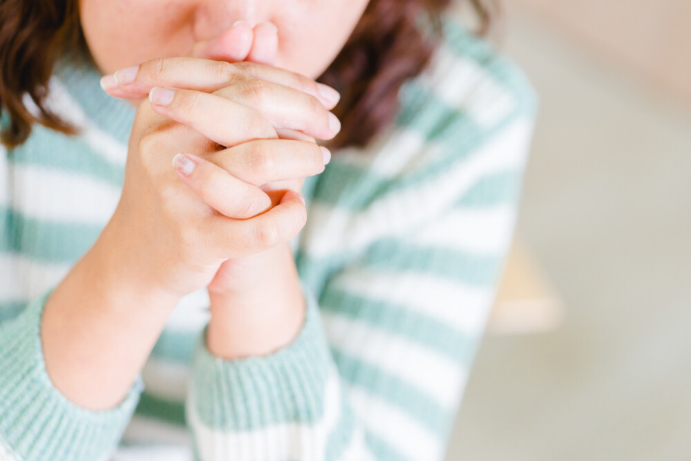 close-up-of-woman-hands-clasped-in-prayer