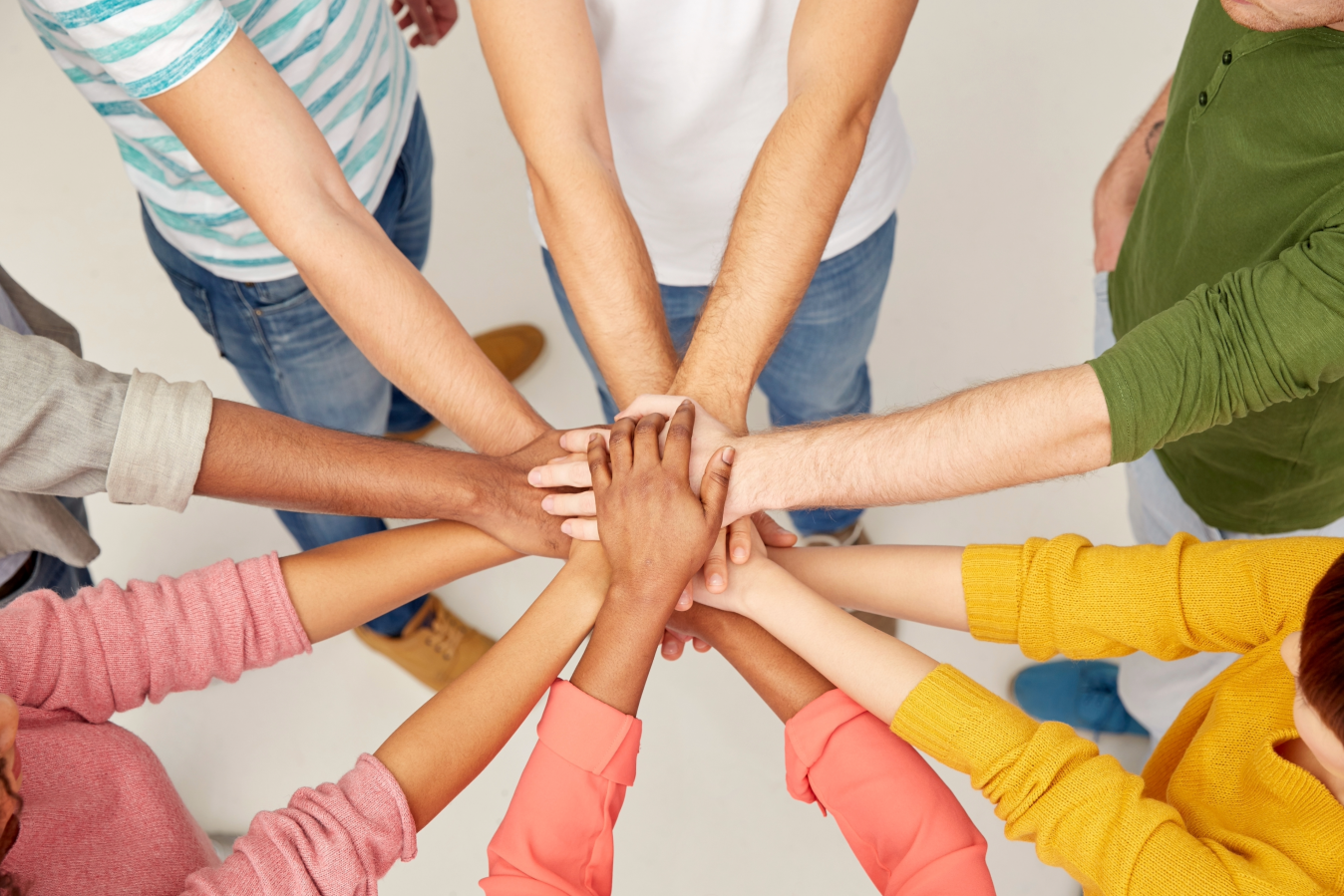 hands reaching together in a circle