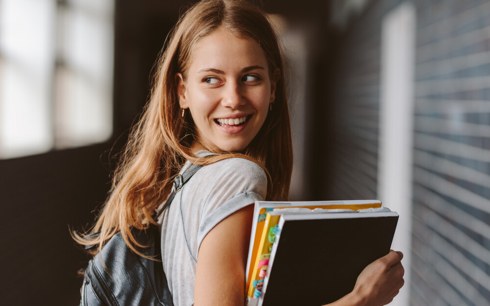 happy-confident-college-girl-carrying-books