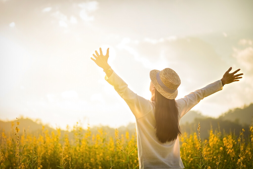 happy-young-woman-arms-raised-to-the-heavens