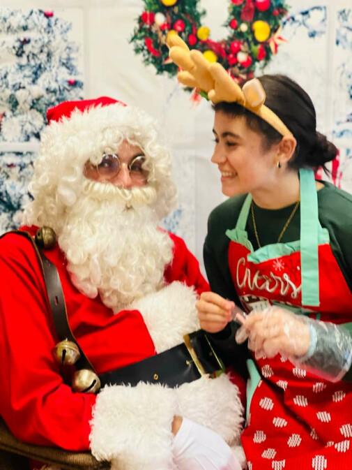 Holly Fair Barista Julia Hajjar tells Santa her wish list.