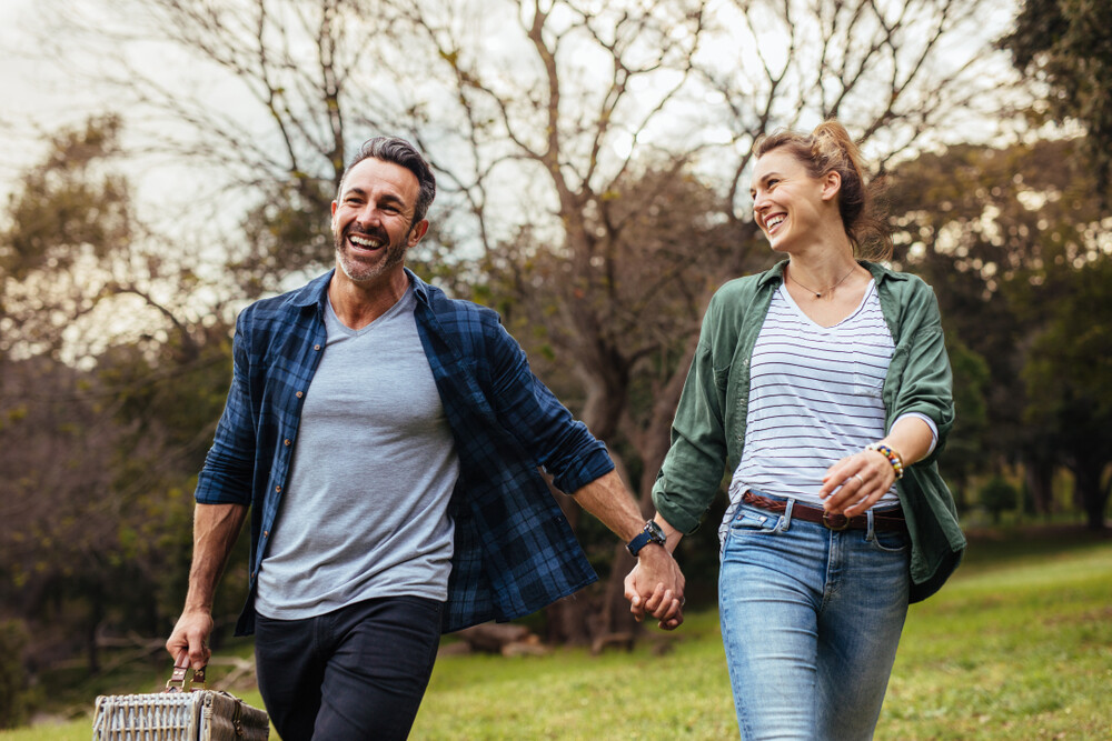 happy-couple-walking-hand-in-hand-for-a-picnic