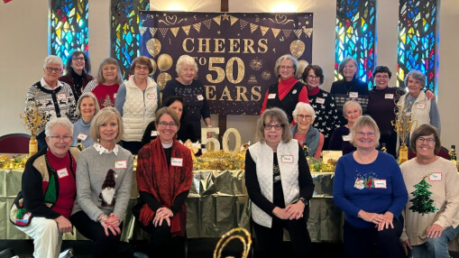 pantry volunteers celebrating anniversary with banner