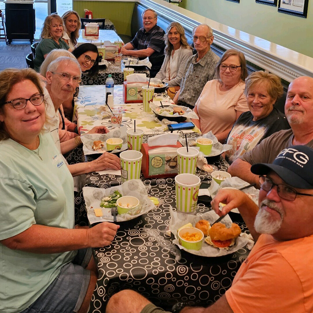 Happy Single Adults Smiling Over Lunch