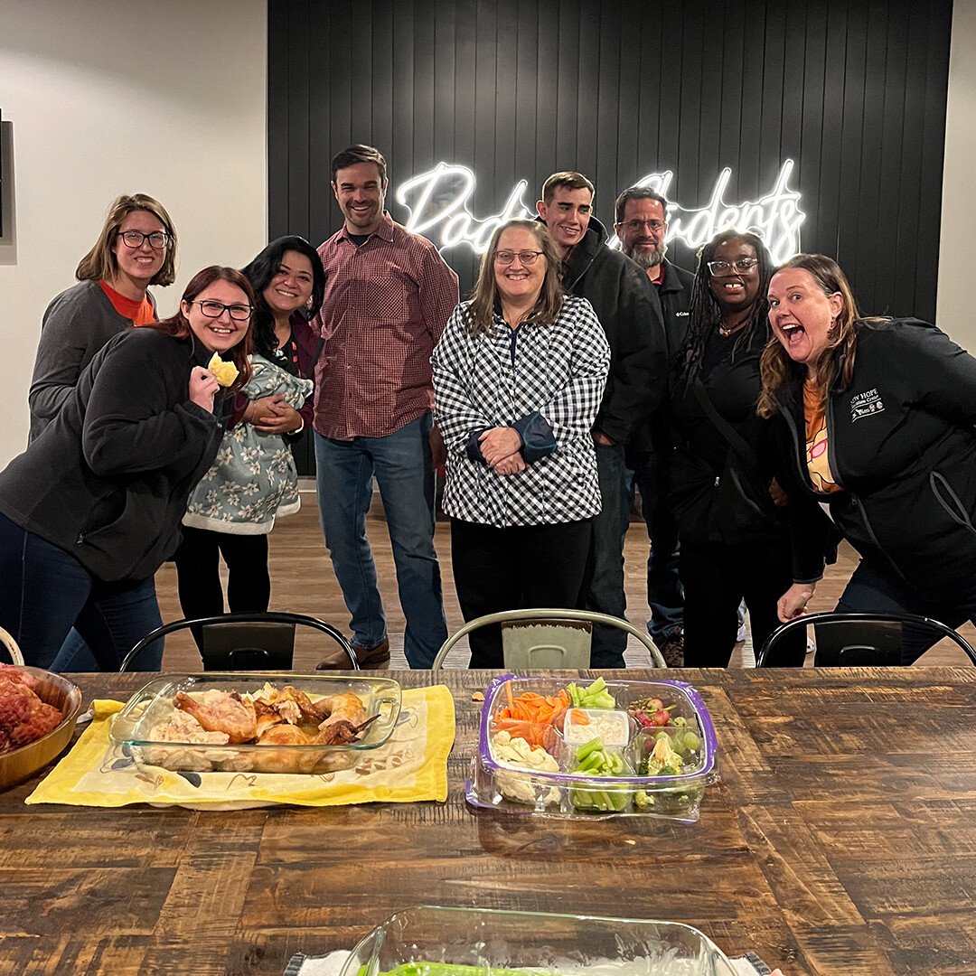 Happy Singles Group Smiling Behind A Delicious Dinner