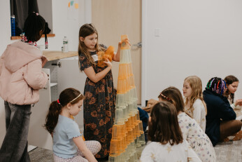 A volunteer playing games with kids