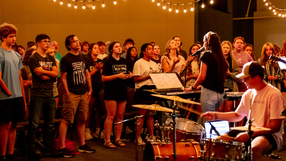 Students singing together at a worship night