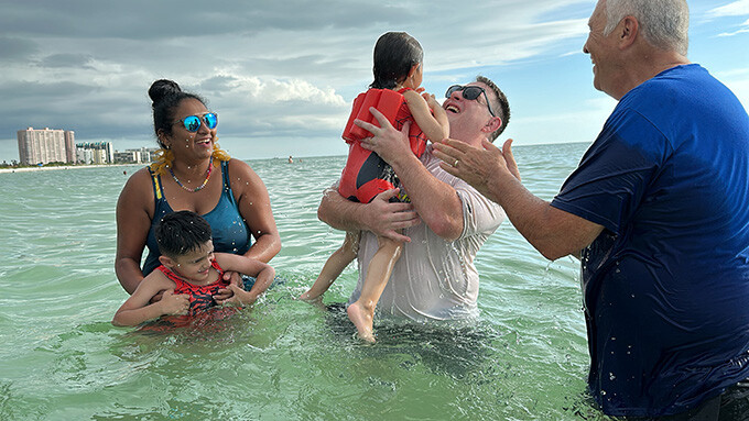 children and their parents being baptized