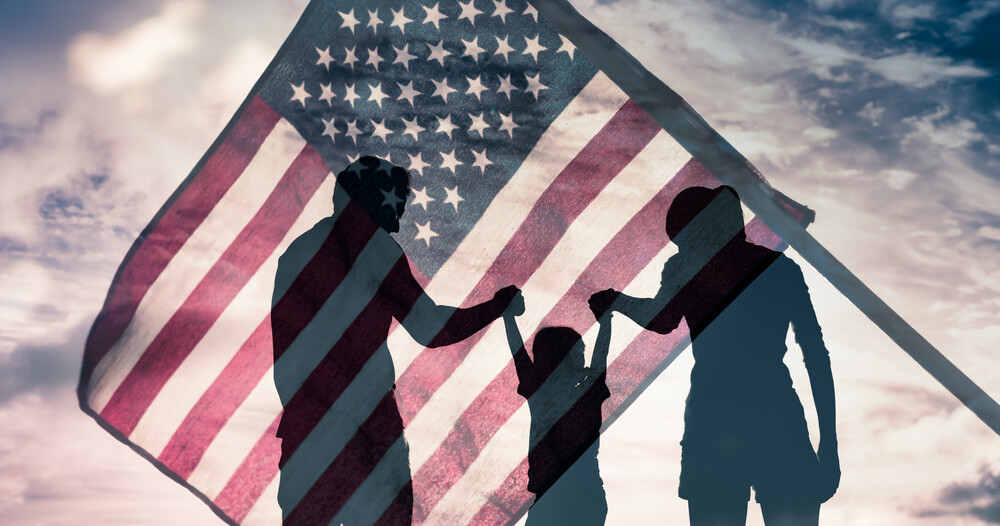 silhouettes-of-family-against-American-flag-backdrop