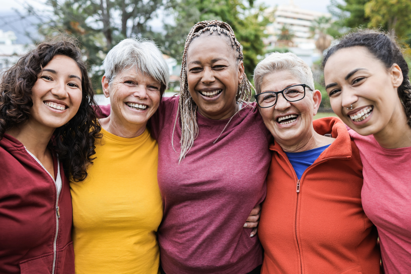 five women standing together and smiling