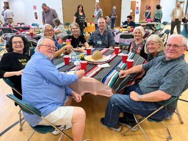 Adults around a table for dinner