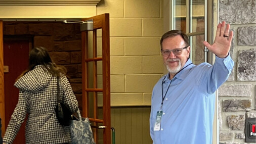 Hospitality Team Greeter waving at the door