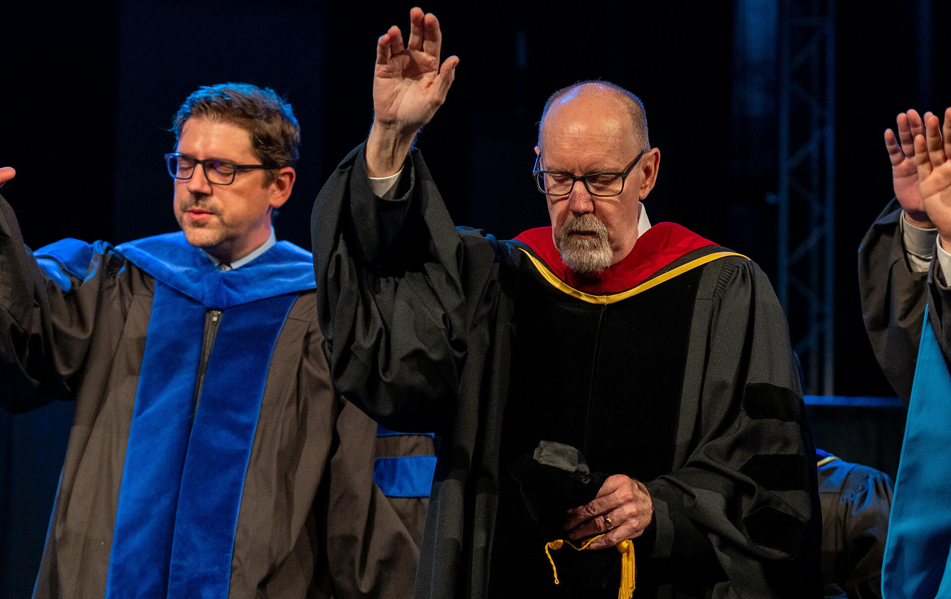 JT Reed praying at spring 2022 commencement.