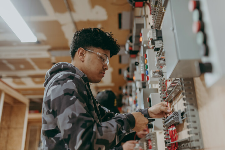 A tudent working on an electrical panel