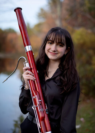 Picture of young woman, Shannon Favela, holding bassoon