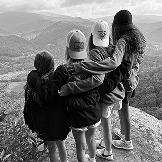Girls on mountain looking out at the view