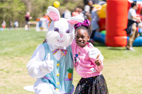 Easter bunny and child grinning at camera