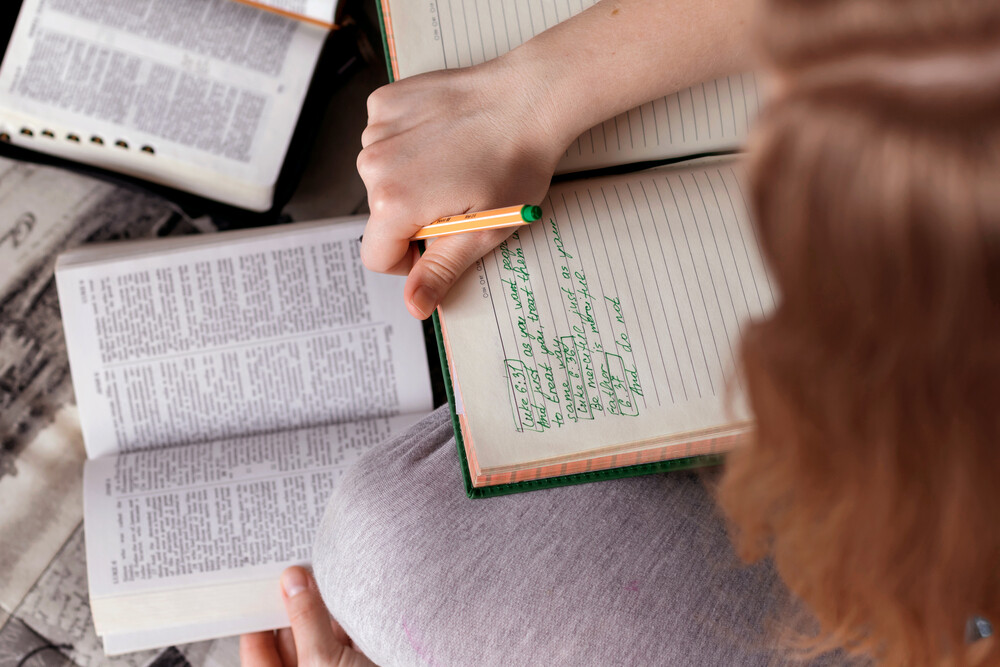 woman-intently-studying-the-Bible-with-notes-and-guides