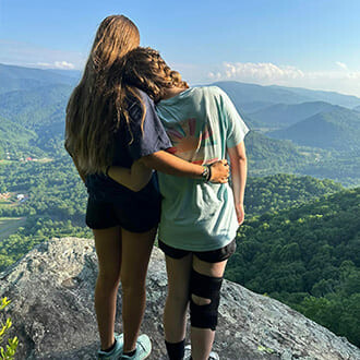 Girls on mountain looking out at the view