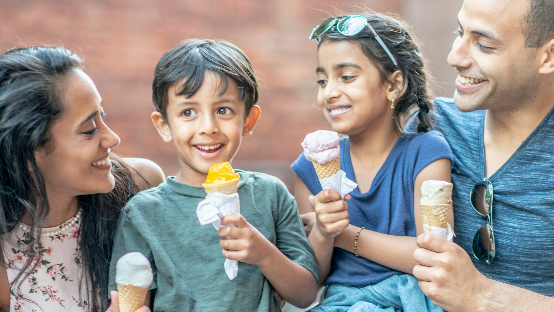 happy-Latino-family-enjoying-ice-cream-together-summertime