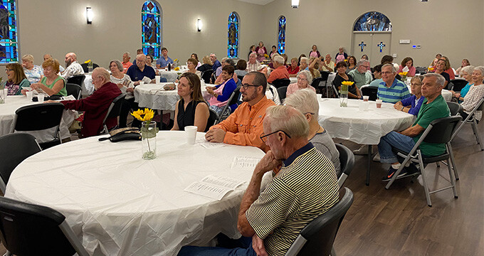 group of people seating at tables to share a meal together