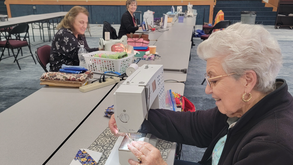 woman using sewing machine