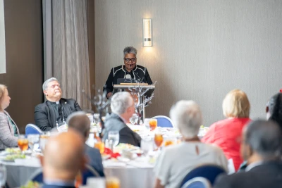 Bishop Easterling speaking at the 2026 retiree luncheon