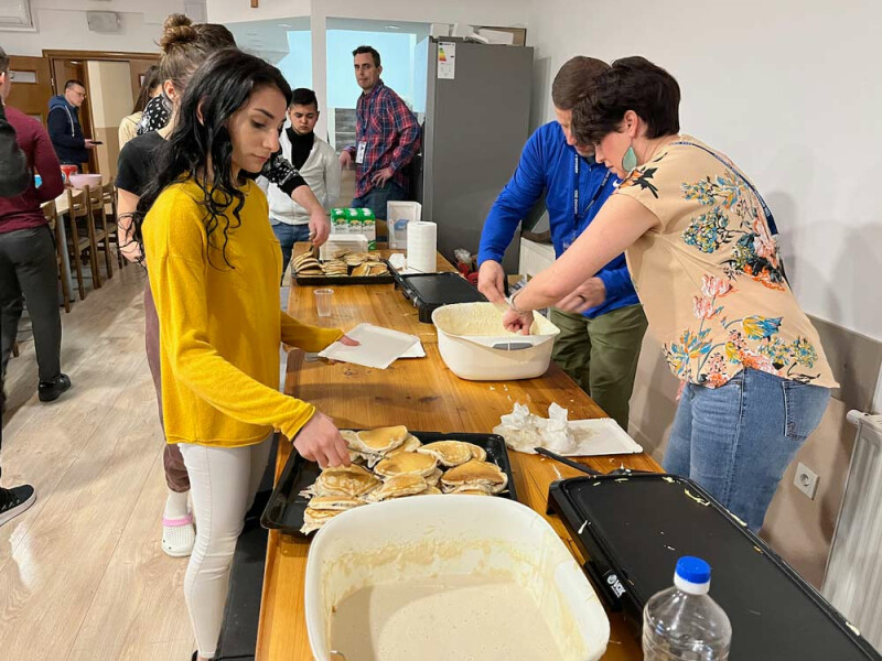 Youth trying American pancakes