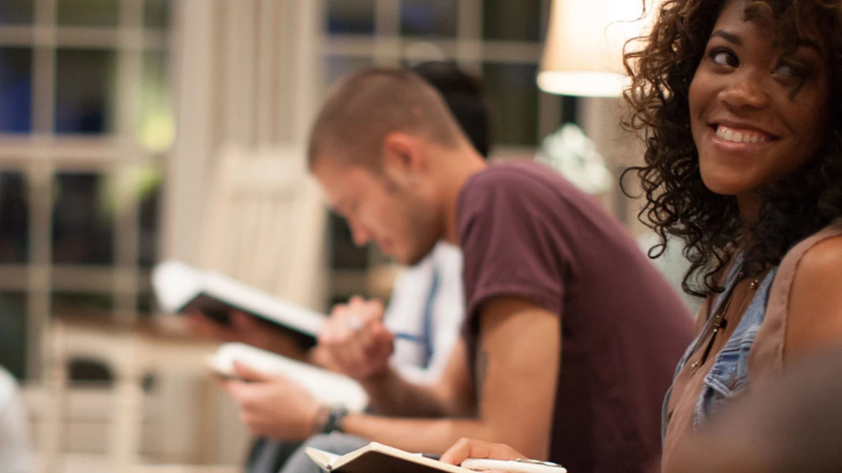 Two adults talking with open Bibles
