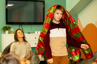 A boy wears a colorful coat learning about Joseph in Sunday School.