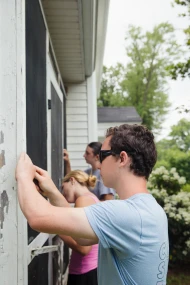 Young people serving together outdoors