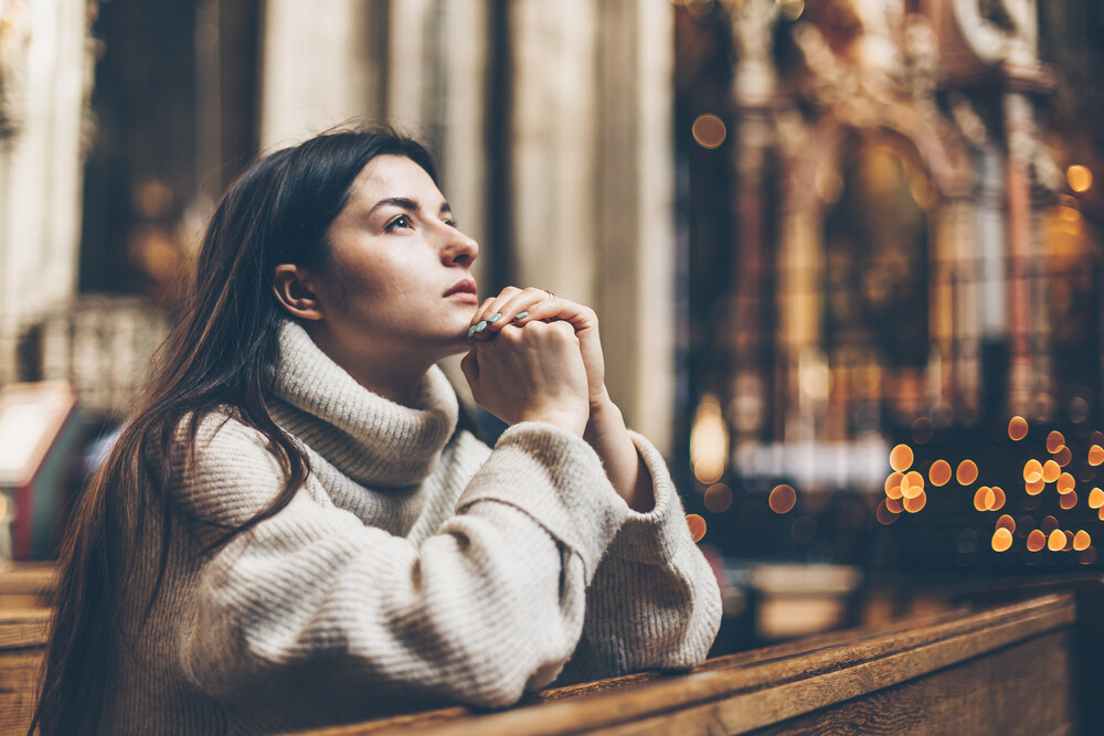 young-woman-sitting-in-church-praying