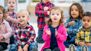 kids listening, clapping and doing hand motions