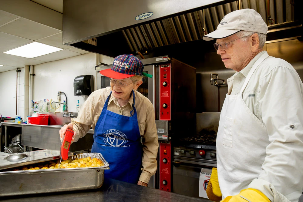 Volunteers prepare meals for a Milwaukee outreach ministry.