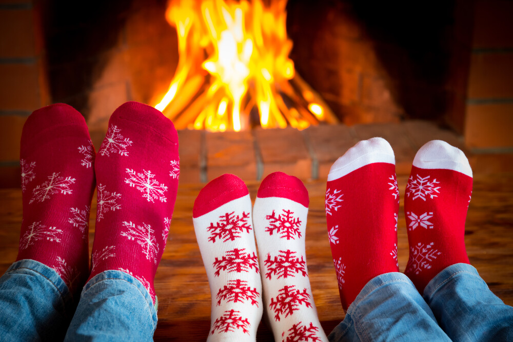 family-in-Christmas-socks-near-fireplace