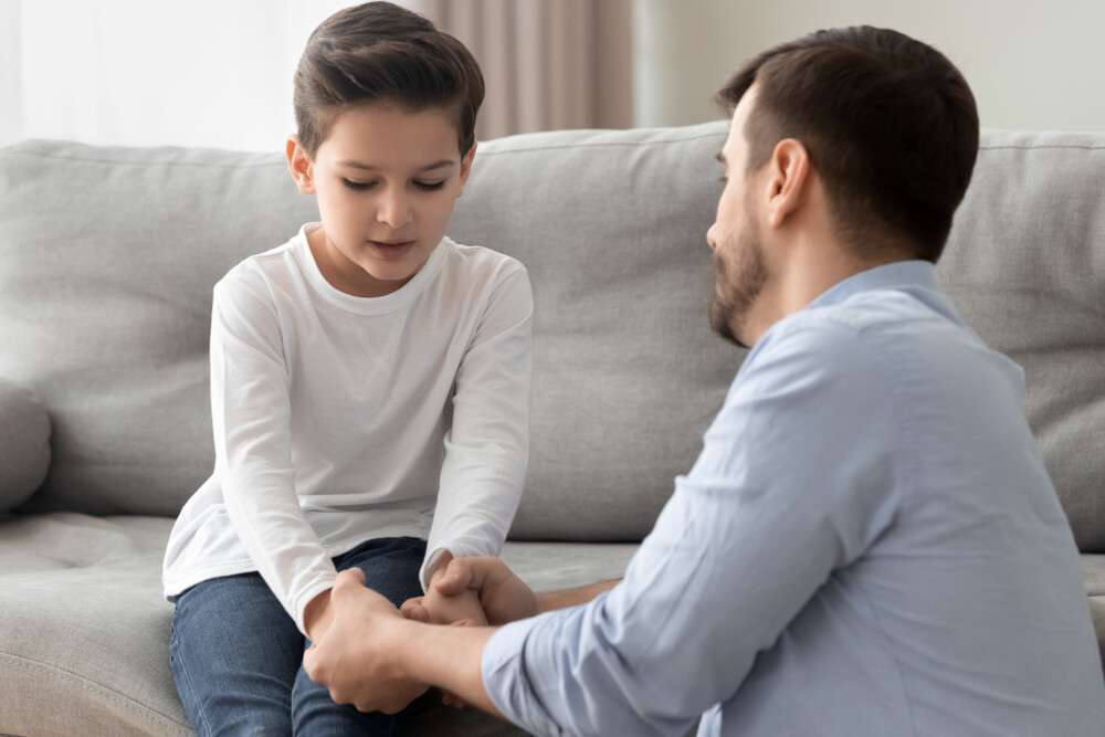 young-father-lovingly-comforting-his-son